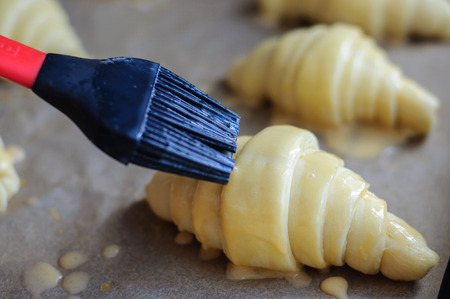 Not baked croissants on oven-trayの写真素材