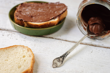 Breakfast with white bread and hazelnut chocolate spreadの写真素材