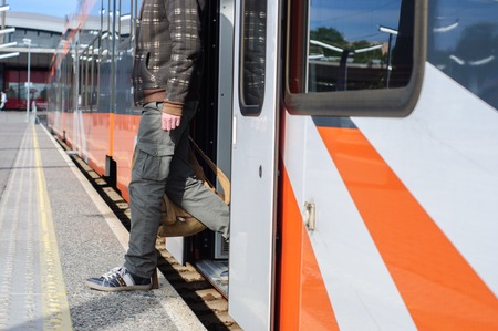 Young tourist man on railway platform near train doorsの写真素材
