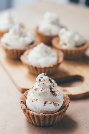 Cooking of little homemade oat tarts with whipped cream
