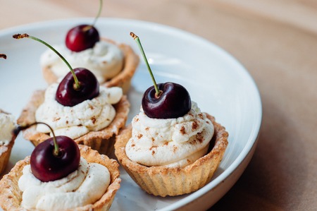 Cooking of little homemade oat tarts with whipped creamの写真素材