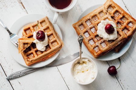 Breakfast with wholegrain brussels waffles and whipped creamの写真素材