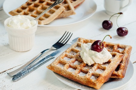 Breakfast with wholegrain brussels waffles and whipped creamの写真素材
