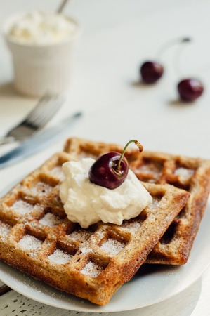 Breakfast with wholegrain brussels waffles and whipped creamの写真素材