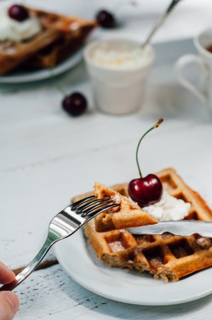 Breakfast with wholegrain brussels waffles and whipped creamの写真素材