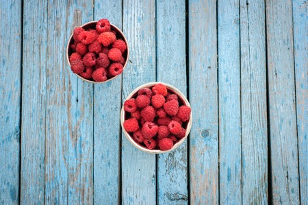 White enamel can and mug with fresh raspberryの写真素材