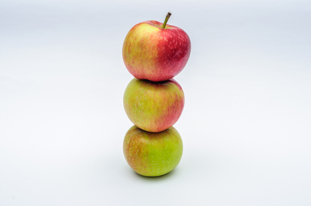 Three red yellow green apples isolated on white backgroundの写真素材