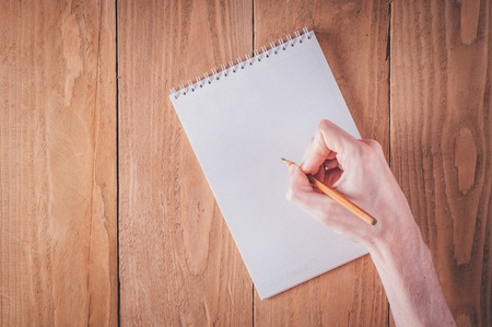 Man hands writing notes in notebook on springの写真素材