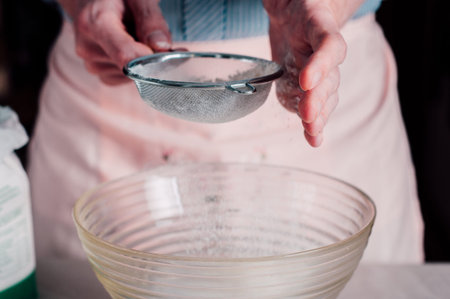 Man chef sifting flour for pizza dough