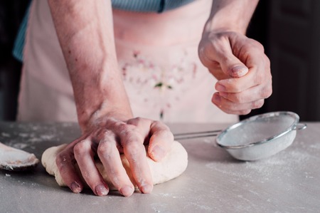 Man chef making dough for pizza Margheritaの写真素材