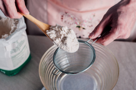 Man chef sifting flour for pizza dough
