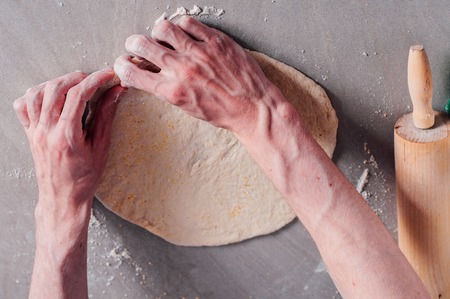 Man chef making dough for pizza Margheritaの写真素材