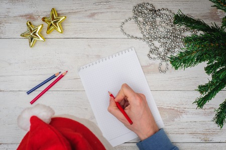 Man writing letter to Santa in Christmas atmosphereの写真素材