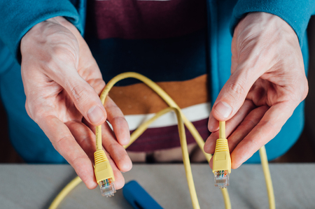 Technician building networking data cable with special toolsの写真素材