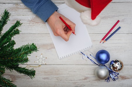 Man writing letter to Santa in Christmas atmosphereの写真素材