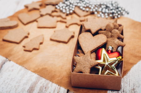 Christmas ginger cookies on white background and baking paperの写真素材
