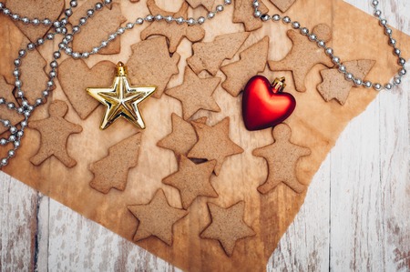 Christmas ginger cookies on white background and baking paperの写真素材