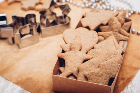 Christmas ginger cookies on white background and baking paperの写真素材