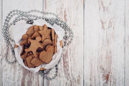 Christmas ginger cookies on white background and baking paperの写真素材