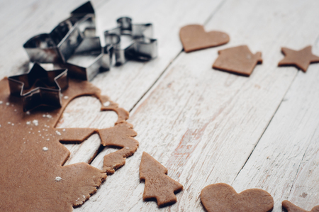 Making christmas gingerbread cookies on white wooden backgroundの写真素材