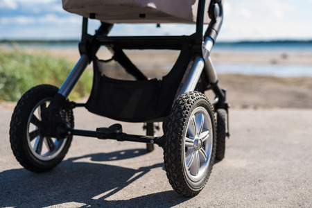 Baby stroller on beach at sunny dayの写真素材