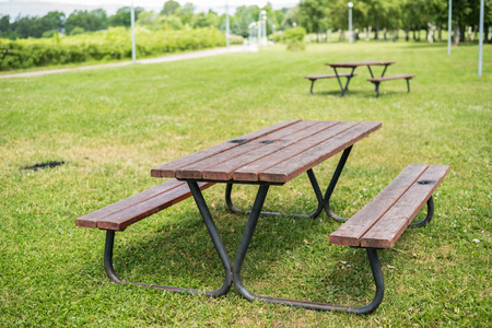 Wooden barbeque table and benches in parkの写真素材