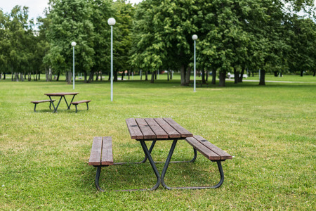 Wooden barbeque table and benches in parkの写真素材