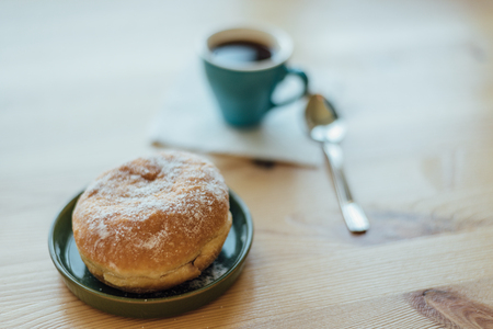 Bismarck doughnut with coffee for breakfastの写真素材