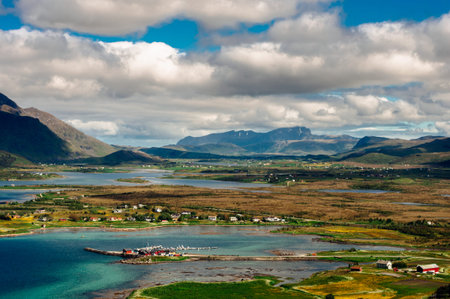 Fjord landscape with little bay near Leknes city and mountains on background, Norway. Beautiful cloudy sky.の写真素材