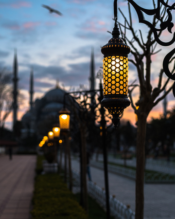 Blue Mosque Sultan Ahmed silhouette with lanterns in bokeh at sunset. Istanbul, Turkeyの写真素材