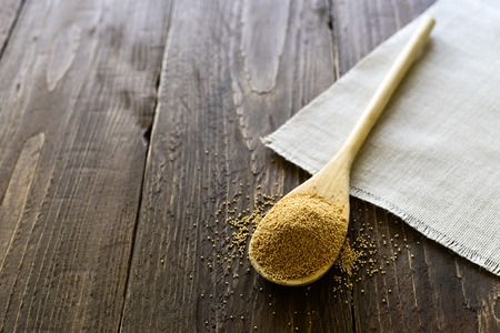 Wooden spoon with raw amaranth seeds on wooden backgroundの写真素材