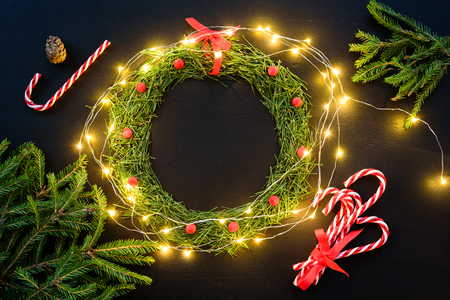 Christmas wreath with lights and decorations on blackboardの写真素材