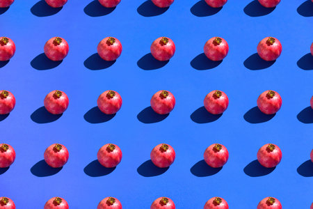 Pomegranates on blue background. Pattern
