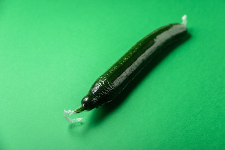 Fresh cucumber in plastic package. Zero waste, recycle concept. Plastic pollution. Green background