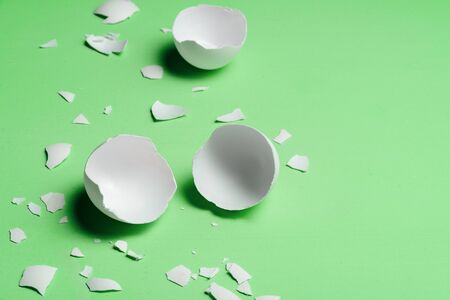 Cracked egg on neo mint trendy background. Text spaceの写真素材