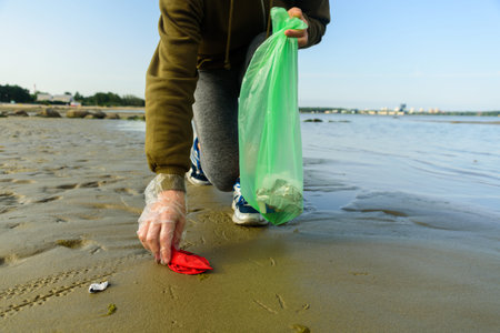 Woman picking garbage on beach. At jogging or running. Plogging concept