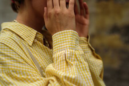 Close up of woman in male oversize yellow shirt. Street styleの写真素材