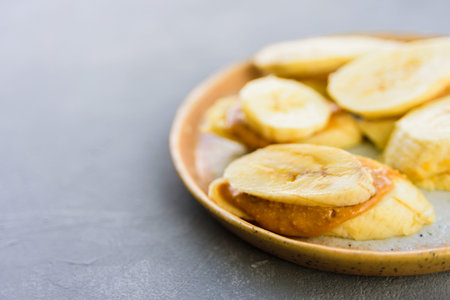 Banana with peanut butter on plate. Healthy snackの写真素材