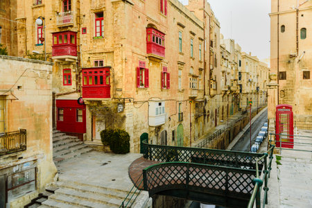 Valletta, Malta - February 18, 2019: Colorful old traditional Maltese balconies in Valletta. Street at eveningのeditorial素材