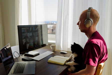Man working from home. Having a video call with his team