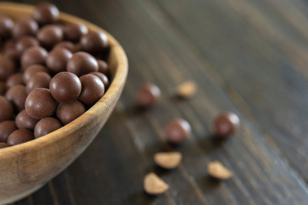 Tibetan medicine herbal pills in wooden bowl. Supplements With Organic Botanical Ingredients