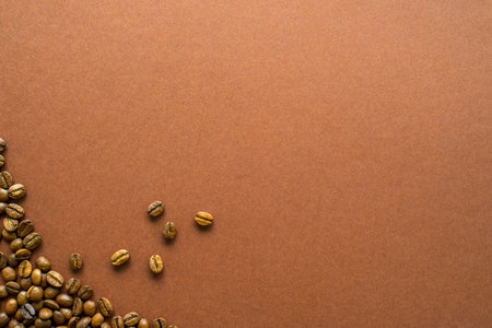 Perfect coffee light roasted beans on brown background close up, flat lay