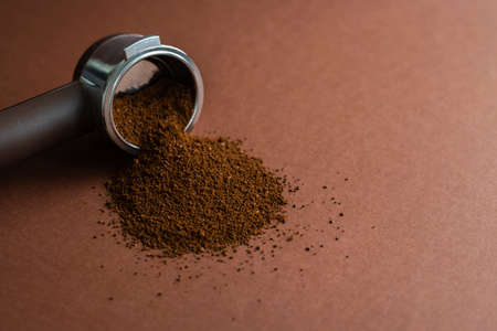 Portafilter coffee machine holder with ground beans on brownの写真素材