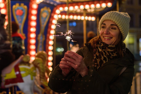 Smiling woman with sparklers on Christmas market in Tallinnの写真素材
