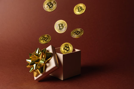 Gift box with flying bitcoins from thereの写真素材