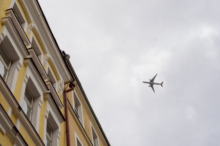 View to flying plane in sky from below.の写真素材