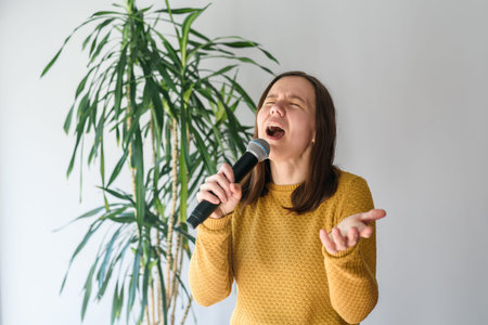 Woman singing with microphone at home with expression
