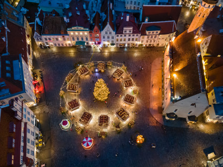 Tallinn, Estonia - December 17 2020: Aerial view to Christmas market in Old Town. Medieval houses with red roofs at eveningのeditorial素材