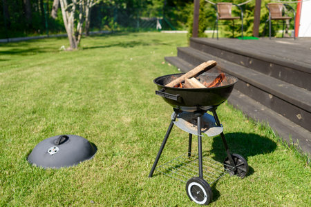 Man preparing grill bbq meat on home backyard at sunny summer dayの写真素材