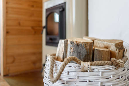 Basket with firewood near country furnace in Estonia Hiiumaaの写真素材
